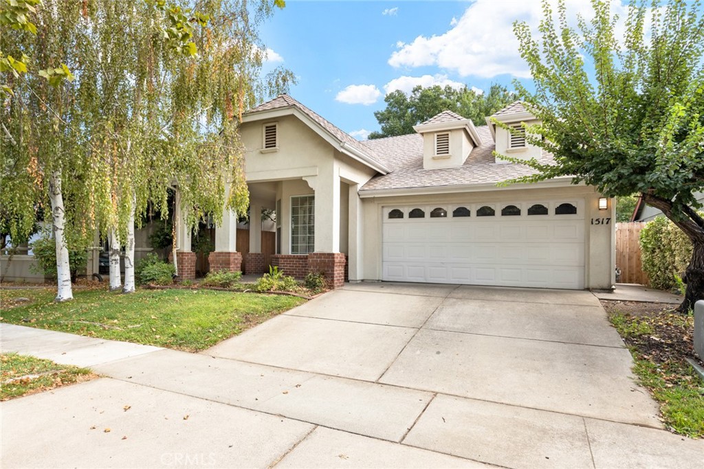 1517 Ridgebrook Way Chico, CA 95928 - Photo 26 of 28 a front view of a house with a yard and garage