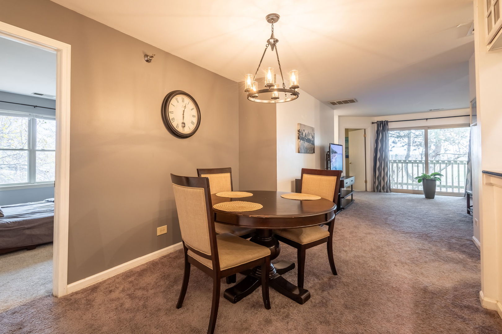 a dining room with furniture a chandelier and a rug