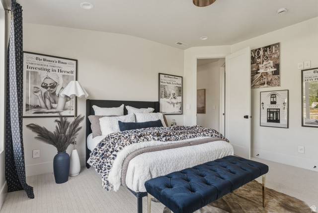 923 North Emery Lane Elk Ridge, UT 84651 - Photo 43 of 101 Bright sleeping area featuring recessed lighting, light-toned carpeting, a paneled door with dark hardware, a window with patterned drapes, and white walls