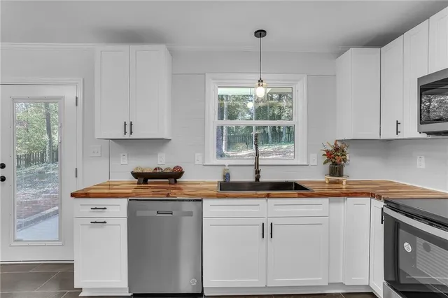 a view of a kitchen with cabinets and wooden floor