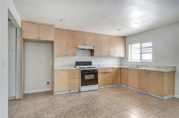 a kitchen with granite countertop white cabinets and stainless steel appliances