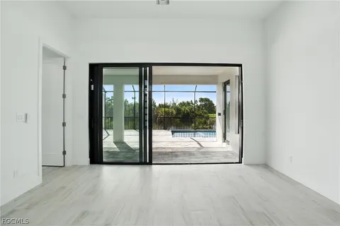 a view of a room with wooden floor and window