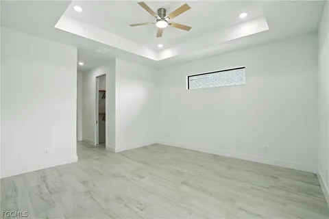 an empty room with closet and a ceiling fan