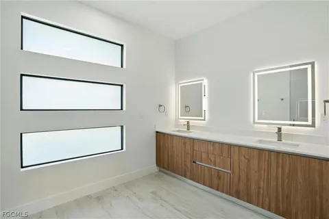 a bathroom with a double vanity sink and a mirror