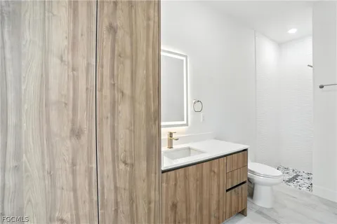 a bathroom with a sink a toilet and shower curtain