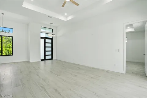 an empty room with windows and closet