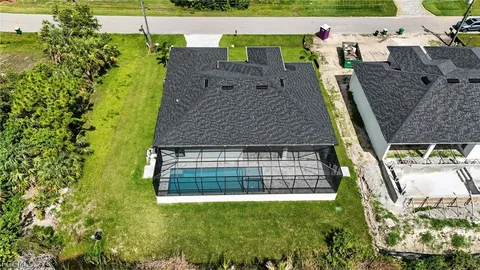 an aerial view of a house with a yard