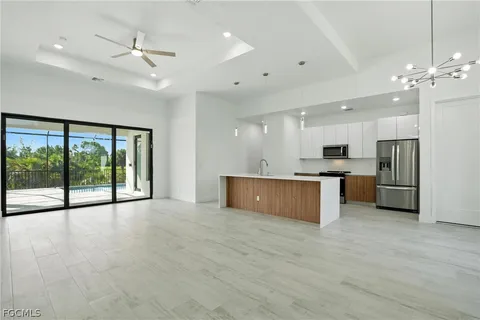 a view of kitchen with refrigerator and microwave