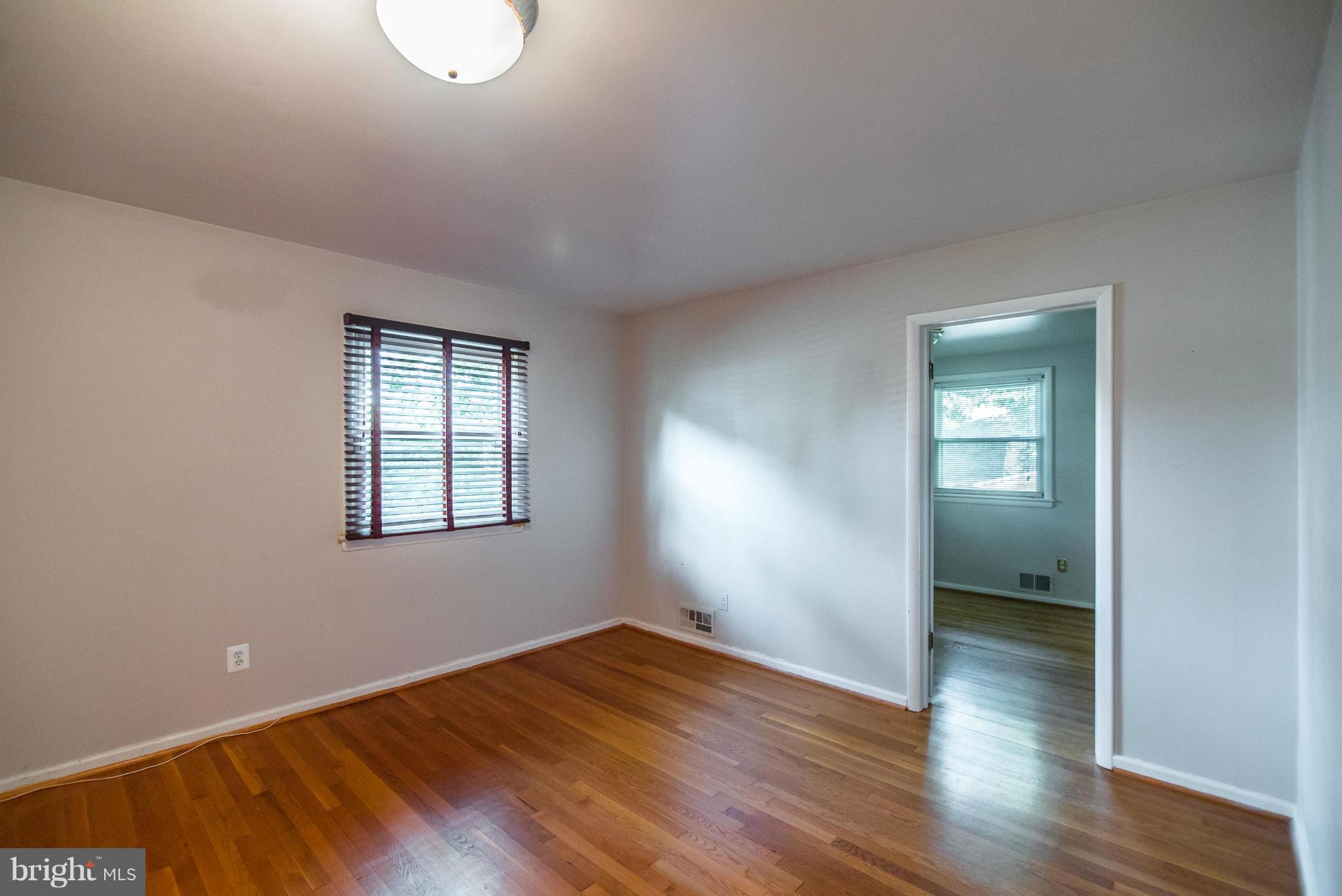 508 Orrin Street Southeast Vienna, VA 22180 - Photo 13 of 30 an empty room with wooden floor and windows