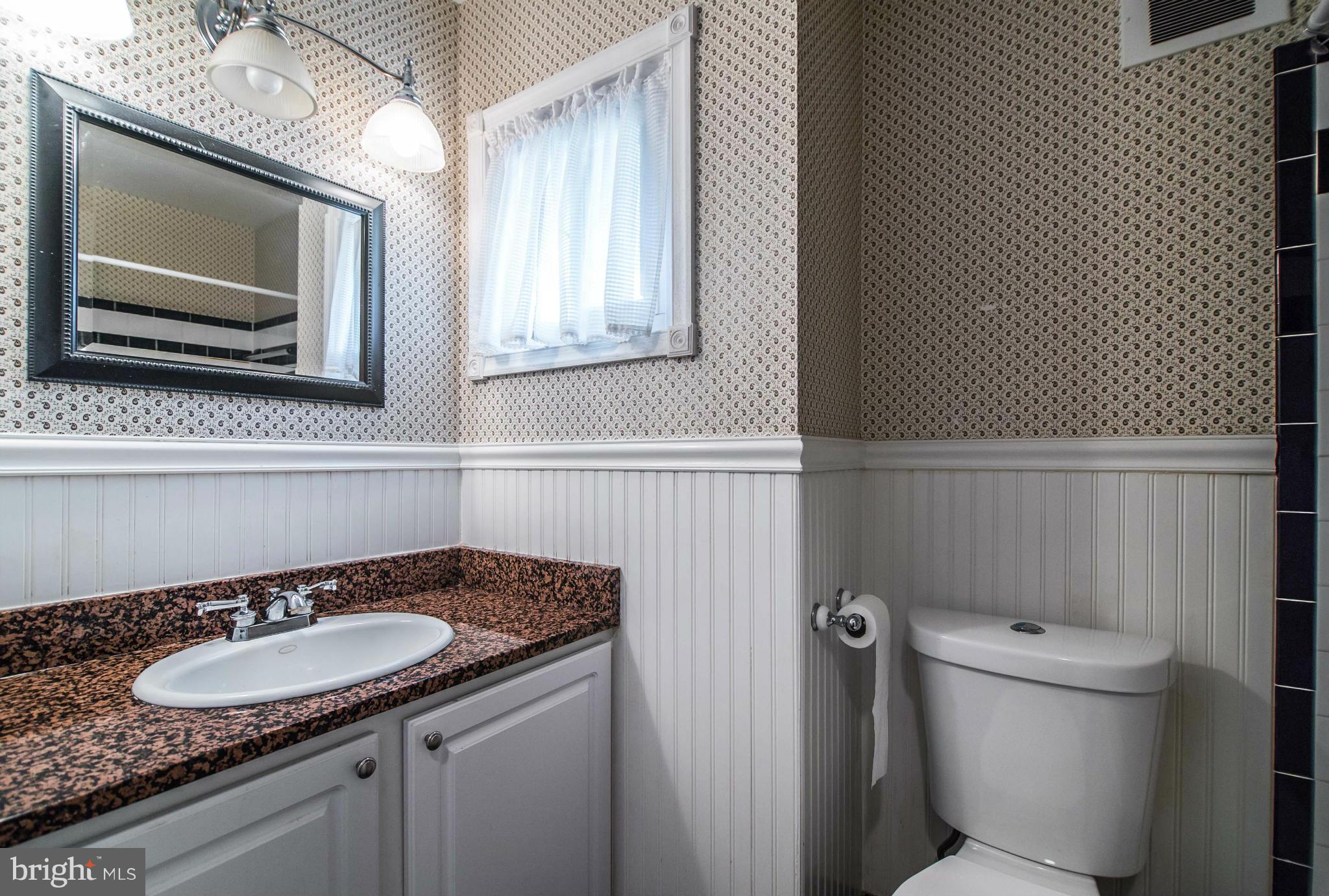 508 Orrin Street Southeast Vienna, VA 22180 - Photo 17 of 30 a bathroom with a granite countertop sink and a toilet