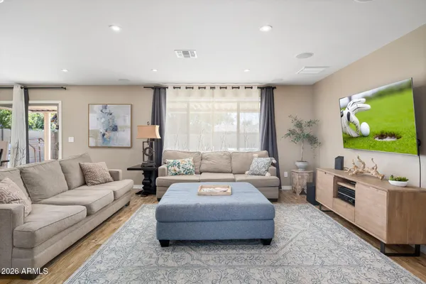 a living room with furniture flat screen tv and a couch