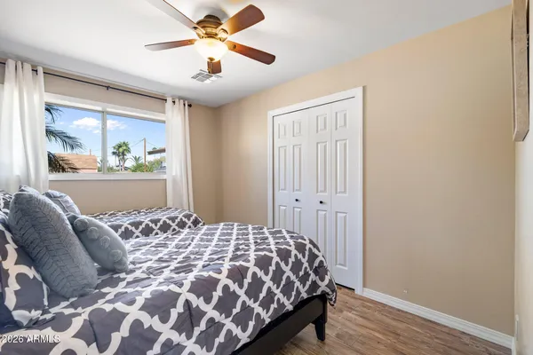 a bedroom with a large bed and a window
