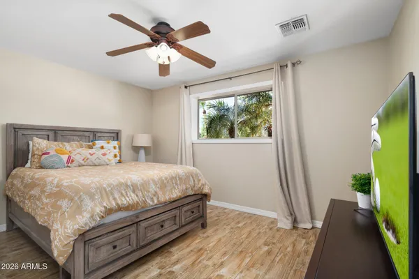 a bedroom with a bed and a chandelier