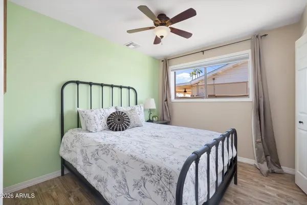 a bedroom with a large bed and a chandelier