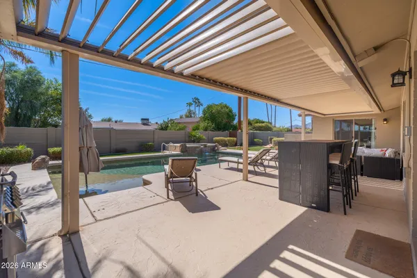 a view of a patio with a dining table and chairs with wooden floor