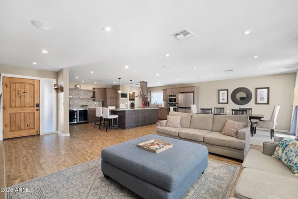 a living room with furniture and a wooden floor