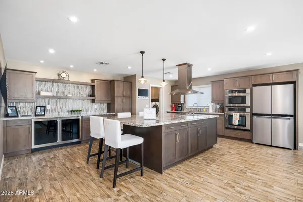 a kitchen with refrigerator and cabinets