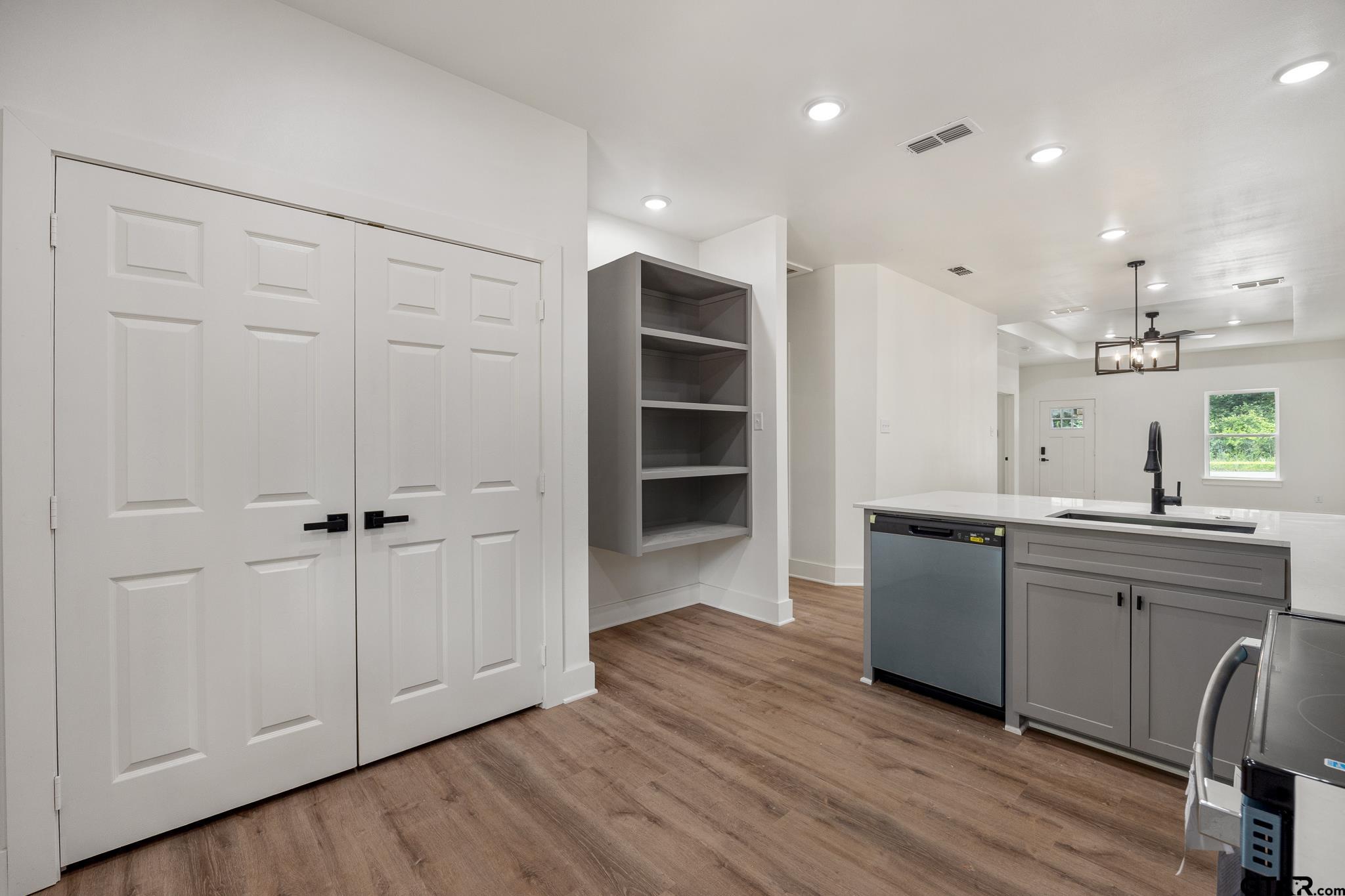 726 Boyd Avenue Tyler, TX 75701 - Photo 15 of 28 a kitchen with kitchen island white cabinets and sink