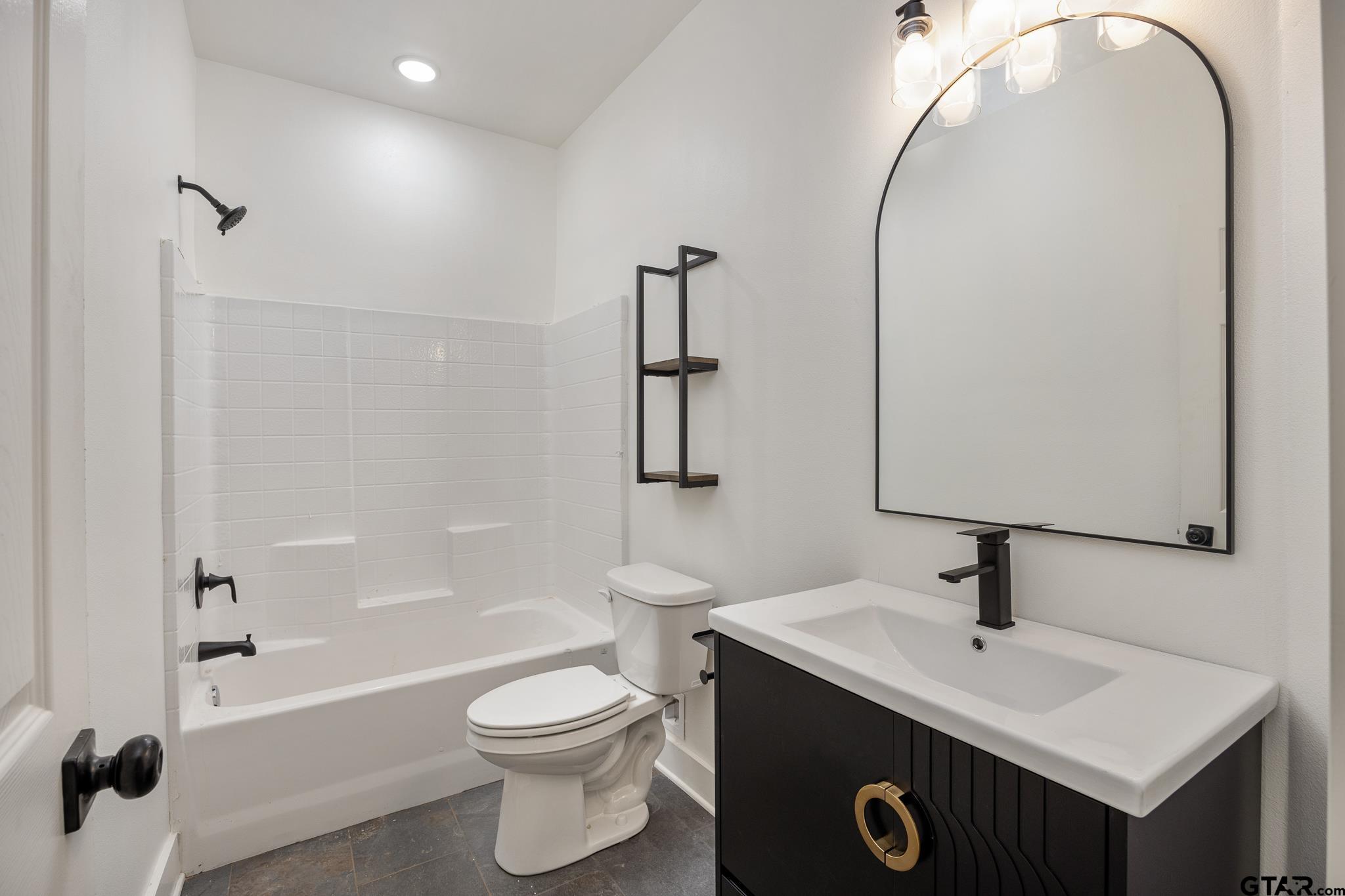 726 Boyd Avenue Tyler, TX 75701 - Photo 20 of 28 a bathroom with a sink a toilet and shower