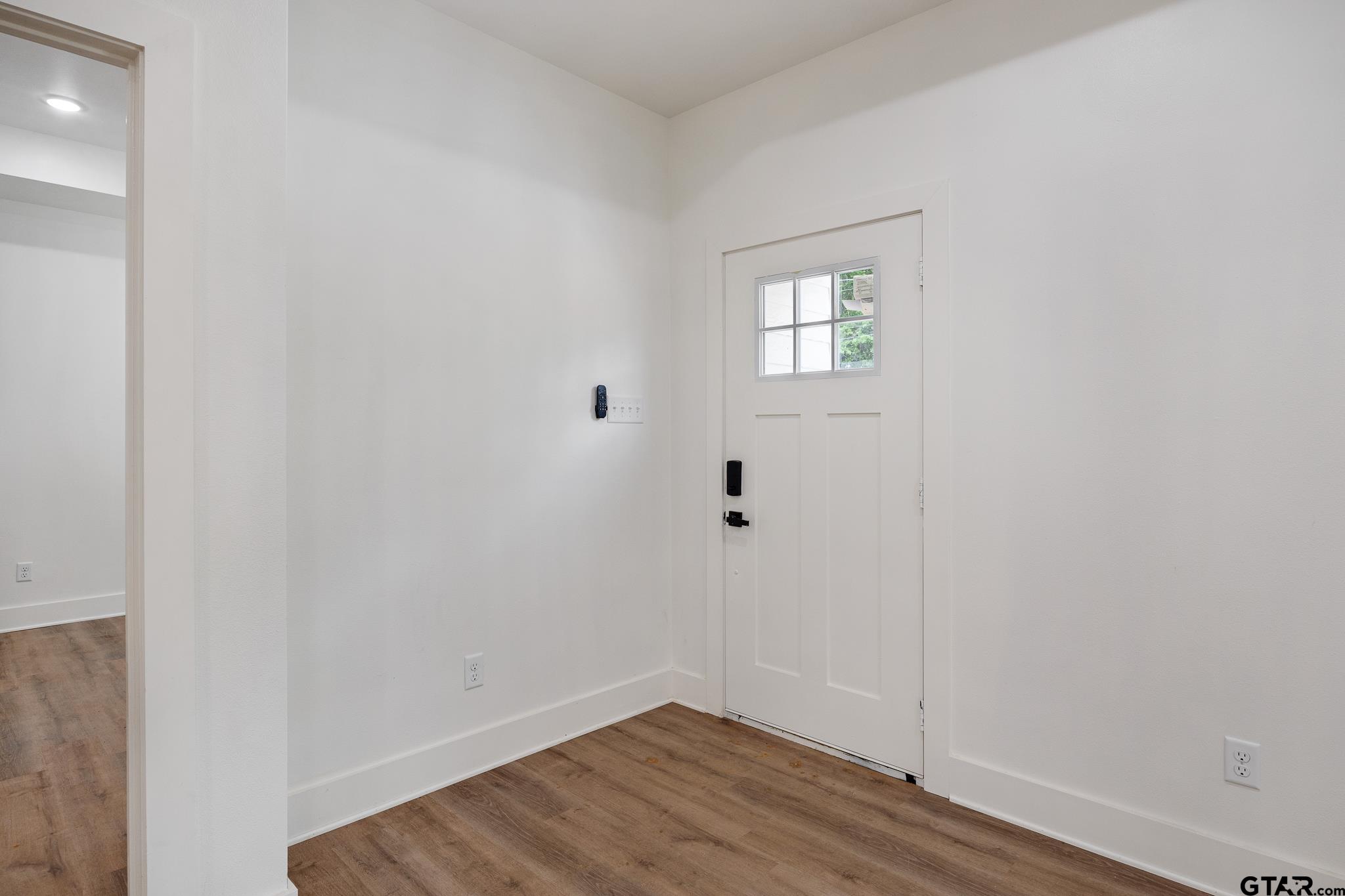 726 Boyd Avenue Tyler, TX 75701 - Photo 4 of 28 a view of an empty room with wooden floor and a window