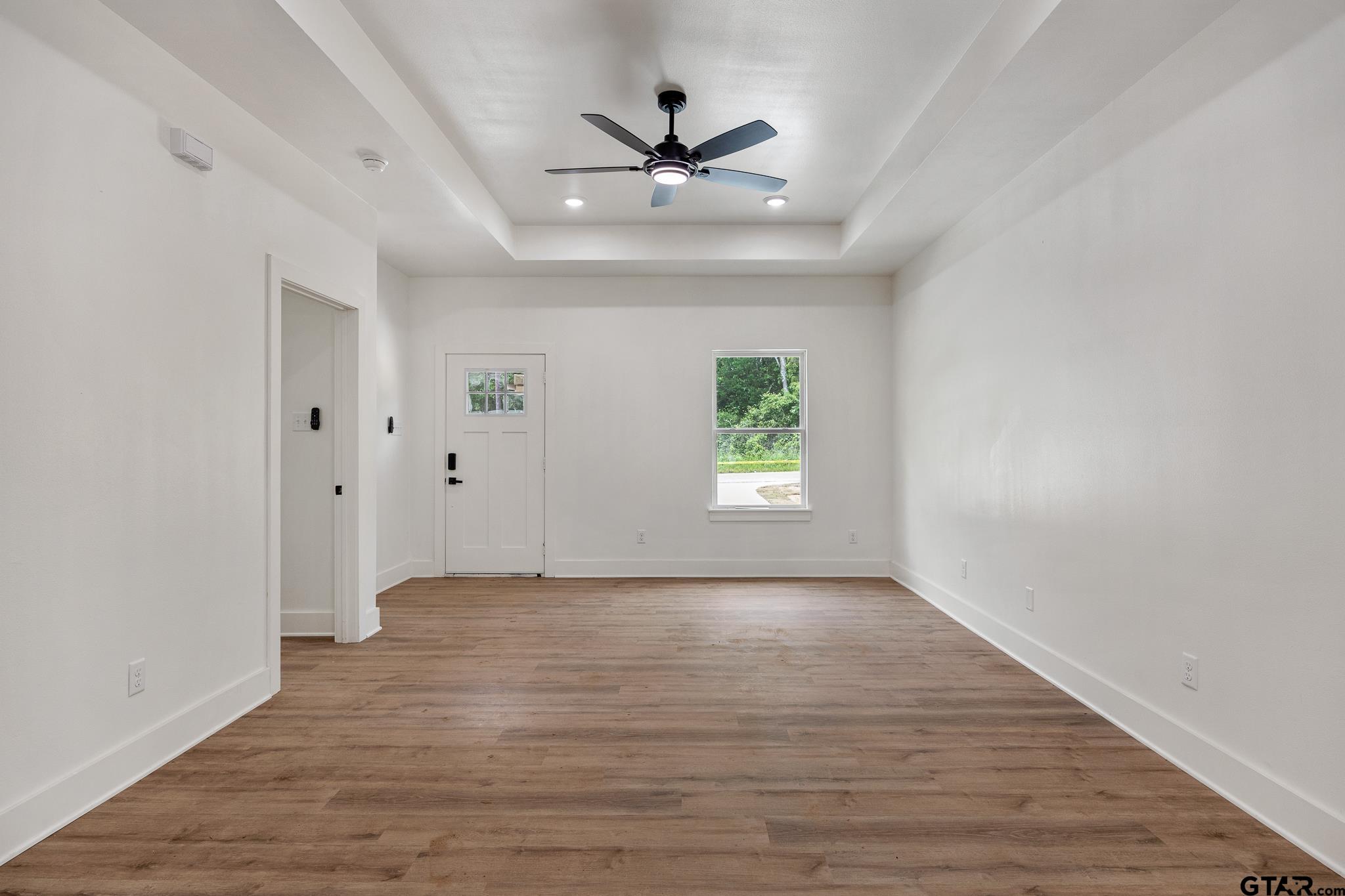 726 Boyd Avenue Tyler, TX 75701 - Photo 6 of 28 wooden floor in an empty room with a window