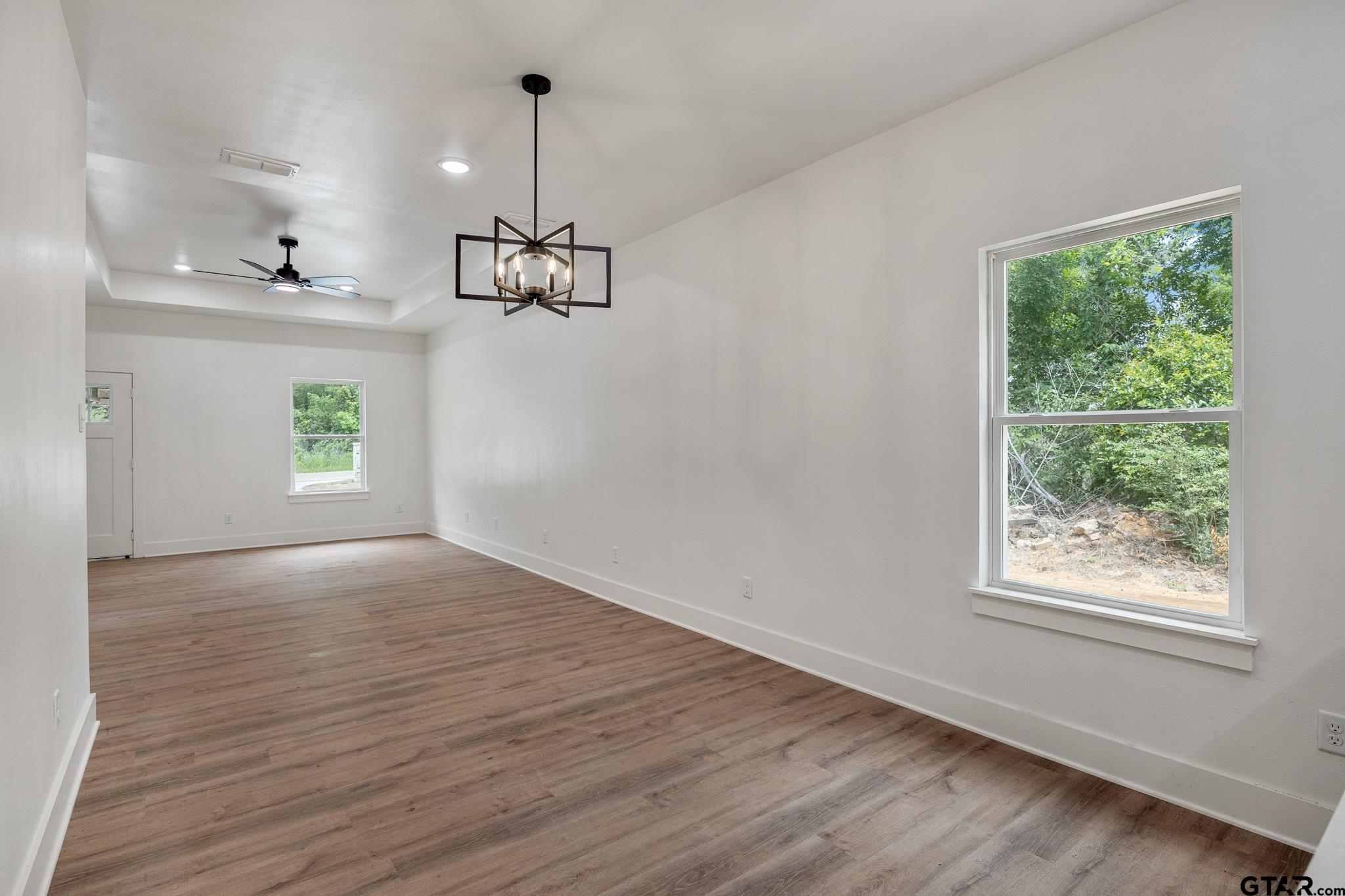 726 Boyd Avenue Tyler, TX 75701 - Photo 9 of 28 a view of an empty room with a window and wooden floor