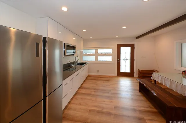 a kitchen with stainless steel appliances granite countertop a refrigerator and a stove