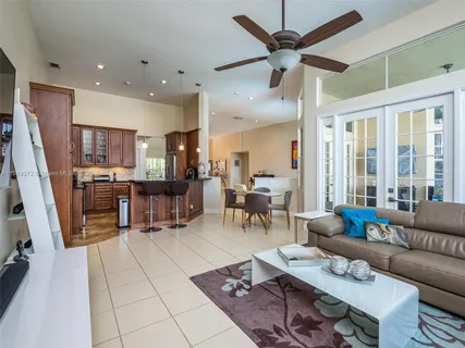 a living room with furniture and kitchen view
