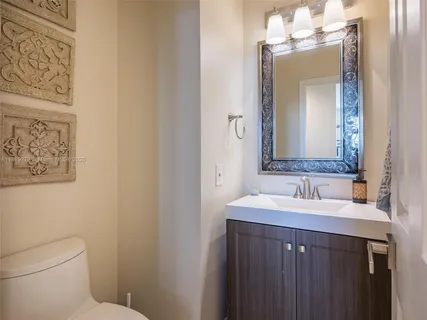 a bathroom with a toilet sink and mirror