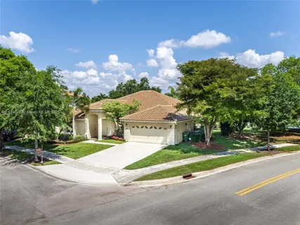 a view of a house with a yard and a fountain