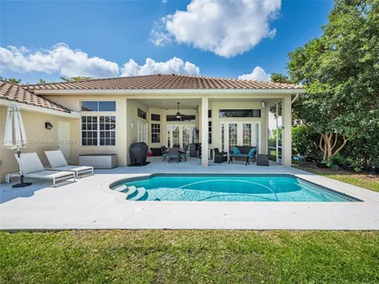 a view of a house with backyard porch and sitting area