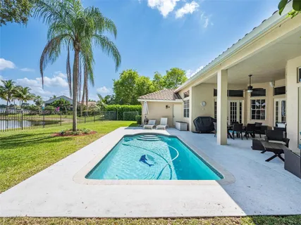 a view of a house with backyard porch and sitting area
