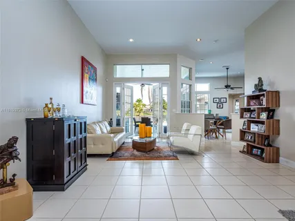 a living room with furniture and large windows