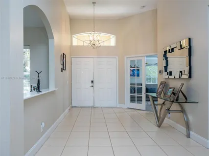 a view of a livingroom with a furniture wooden floor and chandelier