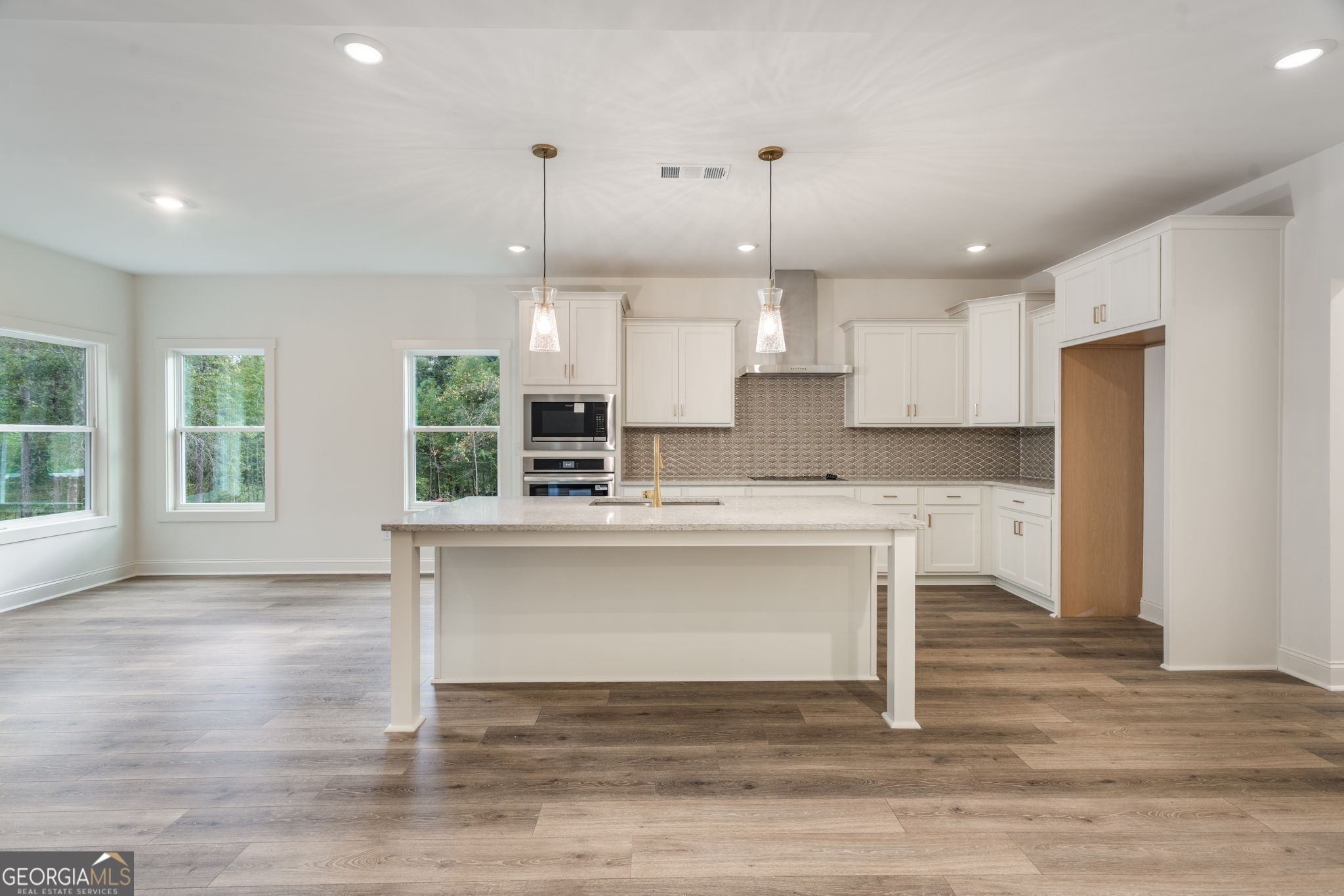 106 Mill Race Road Thomaston, GA 30286 - Photo 12 of 63 a kitchen with kitchen island a counter top space a sink refrigerator and cabinets
