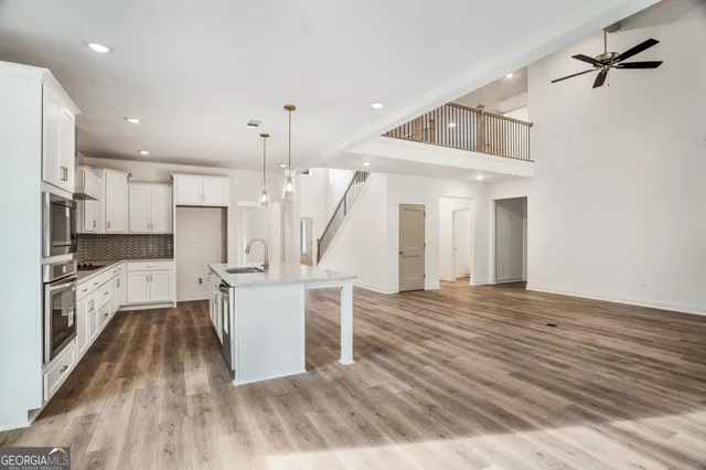 a view of kitchen with refrigerator and wooden floor