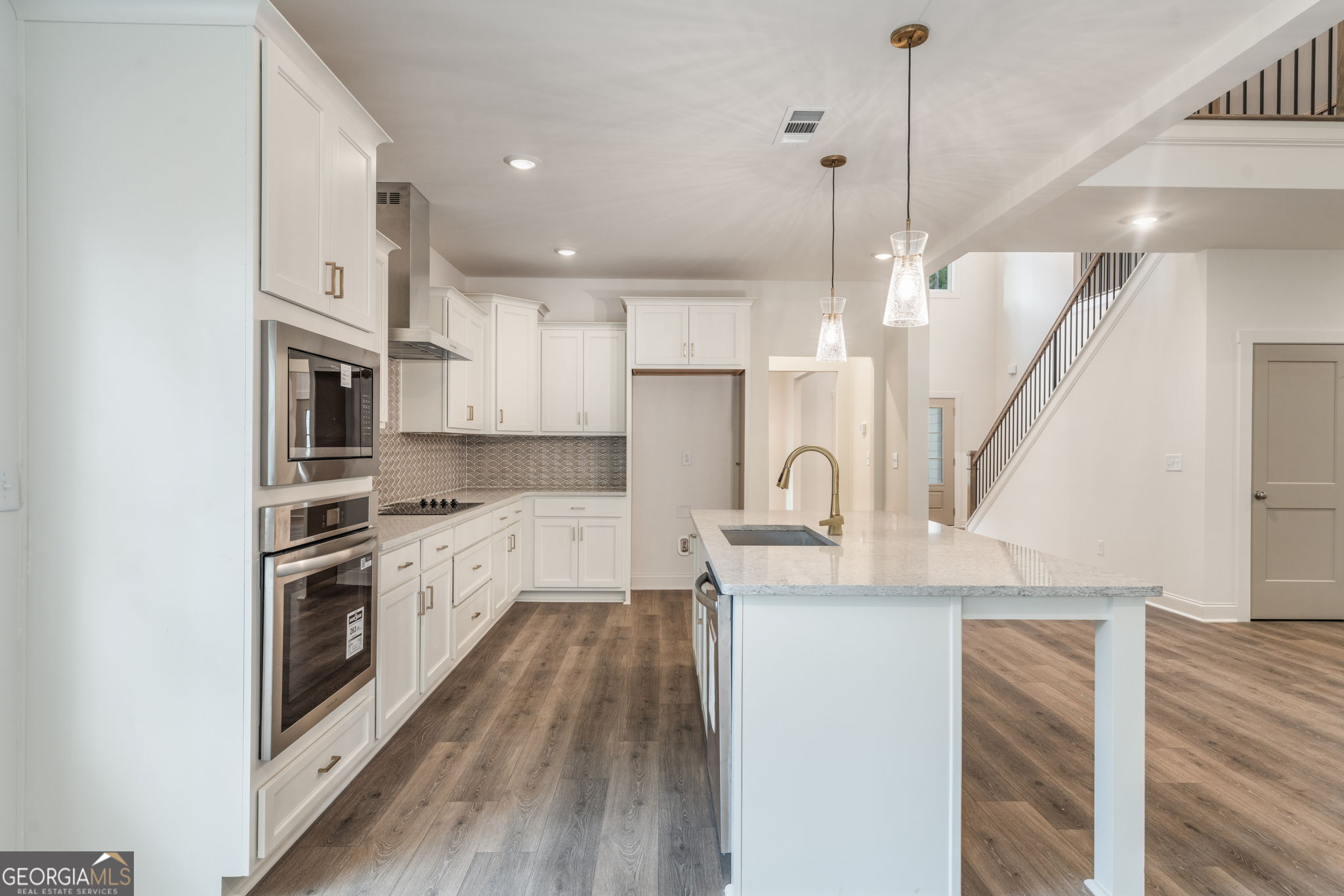 106 Mill Race Road Thomaston, GA 30286 - Photo 16 of 63 a kitchen with stainless steel appliances granite countertop a refrigerator a stove a sink dishwasher a oven with white cabinets and wooden floor