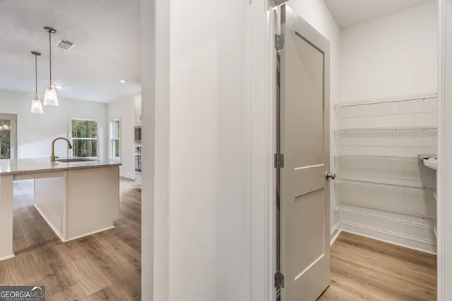 a kitchen with granite countertop a sink a counter space appliances and cabinets