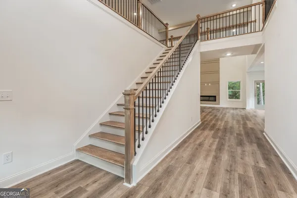 a view of an entryway wooden floor and stairs