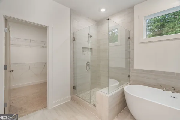 a bathroom with a granite countertop toilet a sink and a mirror