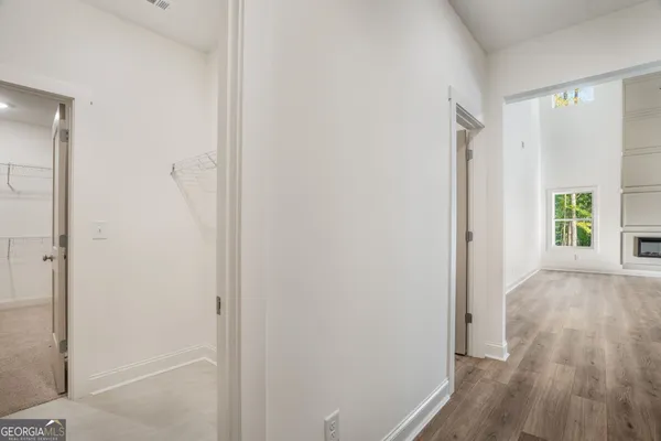a view of entryway and hall with wooden floor