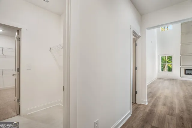 a view of entryway and hall with wooden floor