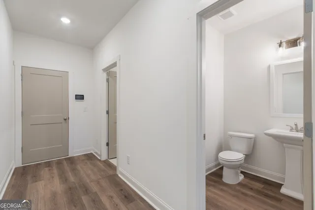 a view of empty room with wooden floor and fireplace