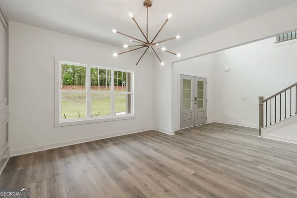 a view of a hallway with a ceiling fan and wooden floor