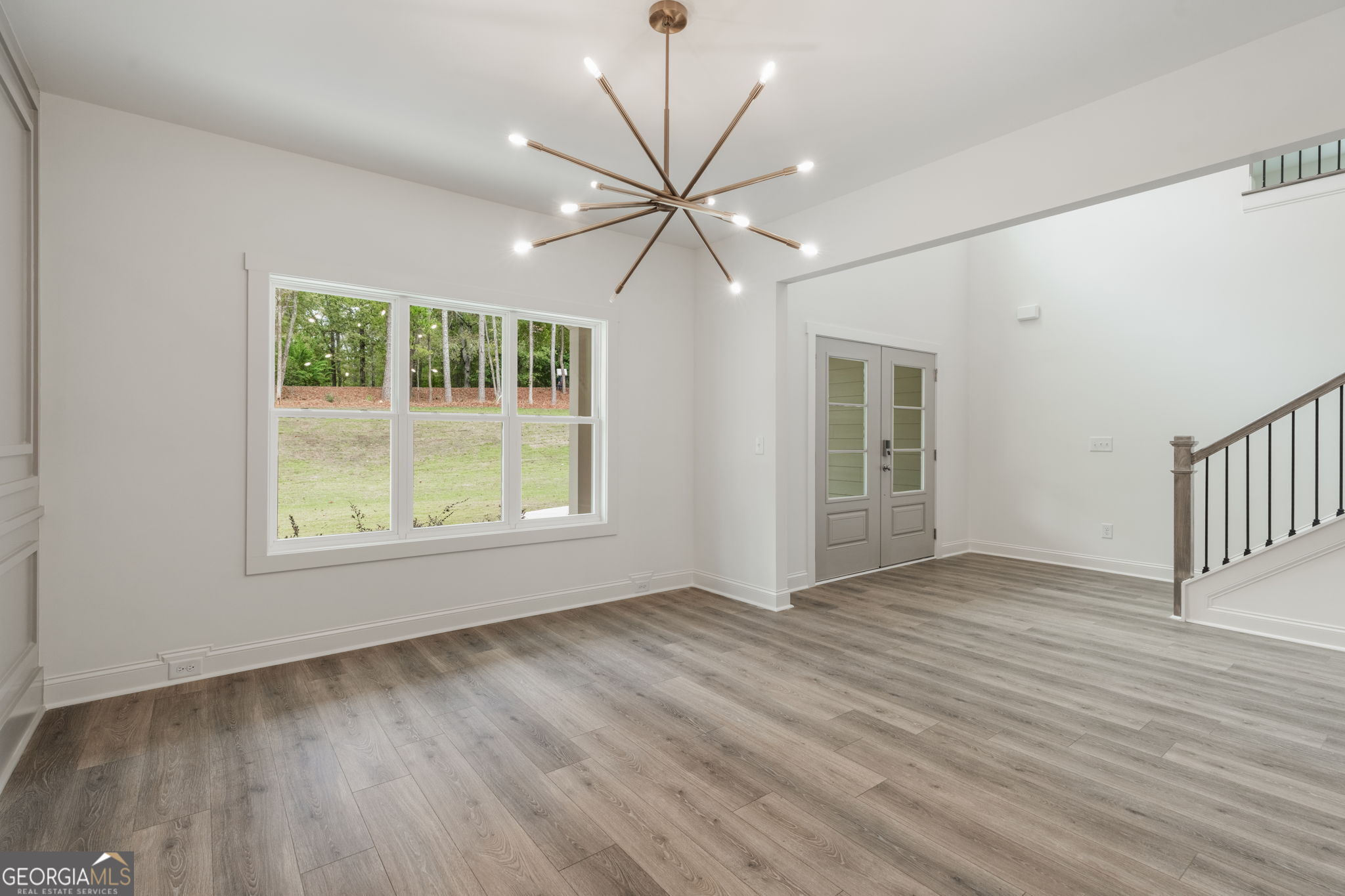 106 Mill Race Road Thomaston, GA 30286 - Photo 4 of 63 a view of an empty room with wooden floor and a window