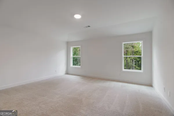 a view of an empty room and closet area
