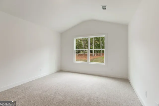a view of a house with a yard and large trees