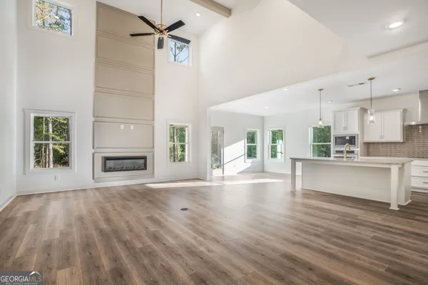 a view of kitchen with kitchen island a sink wooden floor and refrigerator