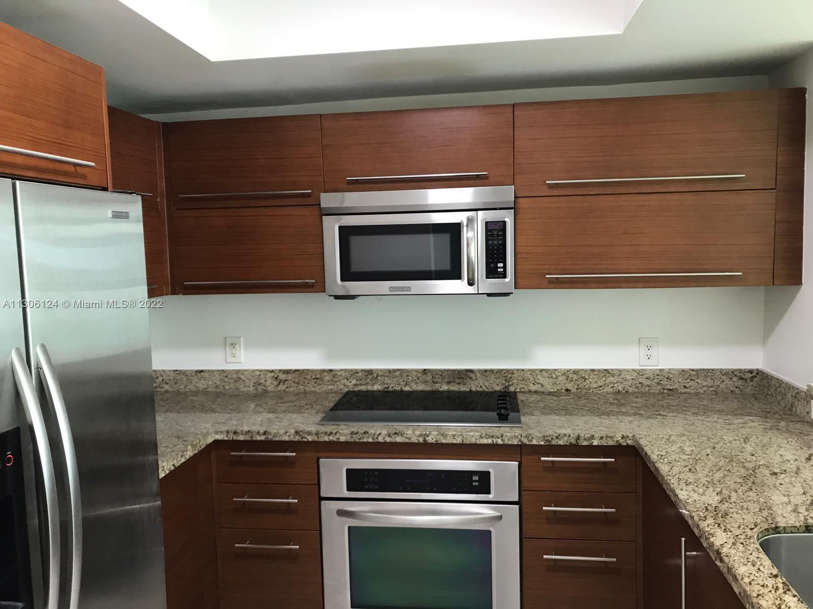 2681 North Flamingo Road, Unit 1905S Sunrise, FL 33323 - Photo 15 of 24 a kitchen with granite countertop a cabinets and steel stainless steel appliances