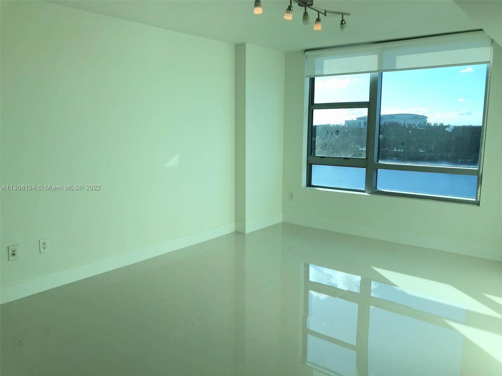 2681 North Flamingo Road, Unit 1905S Sunrise, FL 33323 - Photo 18 of 24 a room with a window and a swimming pool